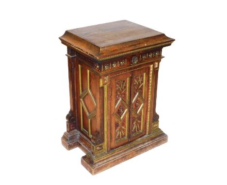 A 19thC Continental gilt oak and simulated faux rosewood cupboard, the square top above a floral carved frieze, over a pair o