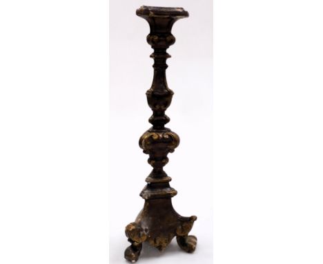 An 18thC European carved and gilt wood altar candlestick, of Baroque form, raised on three scrolled feet, 53cm high.