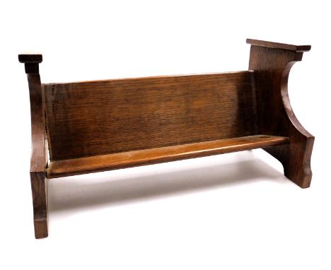 An early 20thC oak book trough, of church pew form, 38cm wide.