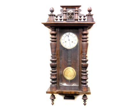 A late 19thC oak cased Vienna wall clock,  circular enamel dial with chapter ring bearing Roman numerals, eight day movement 