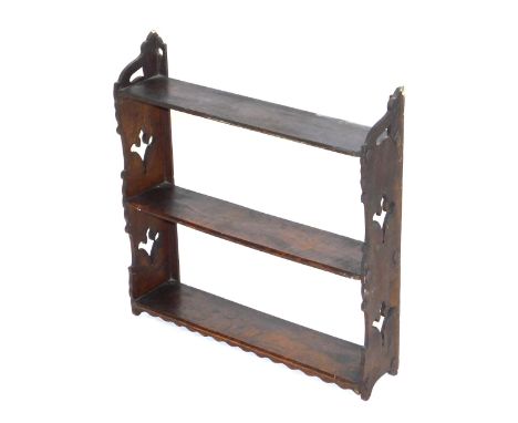 A 19thC oak hanging wall shelf, of three shelves, raised on carved ends, 51cm high, 50.5cm wide.