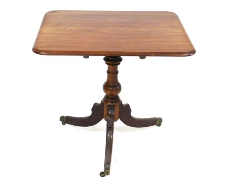 A George III mahogany tilt top occasional table, the rectangular top raised on a ring turned and vase shaped column over thre