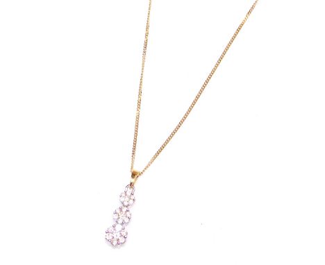 An 18ct yellow, white gold and diamond pendant, of three tiered graduated floral form, set with twenty one diamonds, on a cur