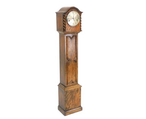 An early 20thC oak cased Grandmother clock, with a circular silvered dial bearing Arabic numerals, eight day movement with We