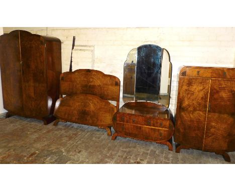 An Art Deco walnut bedroom suite, comprising a double wardrobe, with two drawers opening to reveal a shelf, hanging rails and