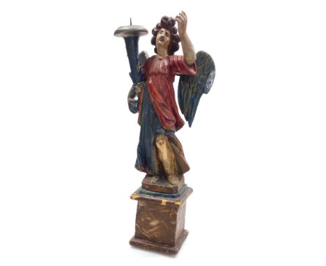 A late 17thC Continental pricket candlestick, possibly Italian, carved as an angel and painted in polychrome colours, raised 