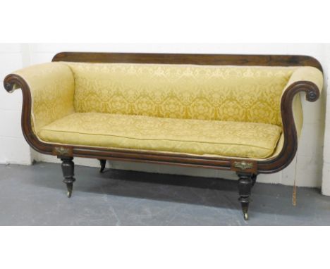 A Regency rosewood two seater sofa, with scrolling arms, loose cushion seat, all upholstered in gold floral patterned damask,