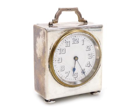 A George V silver cased travel clock, the circular white enamel dial bearing Arabic numerals, clockwork movement, the case of