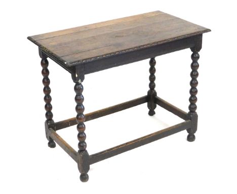 A 17thC oak occasional table, raised on bobbin turned legs, united by a box stretcher, 70cm high, 87cm wide, 48cm deep.