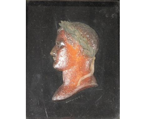 An early 19thC wax profile bust portrait of the Emperor Napoleon I, signed indistinctly, framed and glazed, 16cm x 12.5cm.