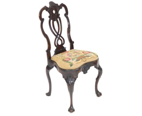 An 18thC Dutch walnut dining chair, with foliate carved and pierced splat, woolwork tapestry seat, raised on rococo foliate c