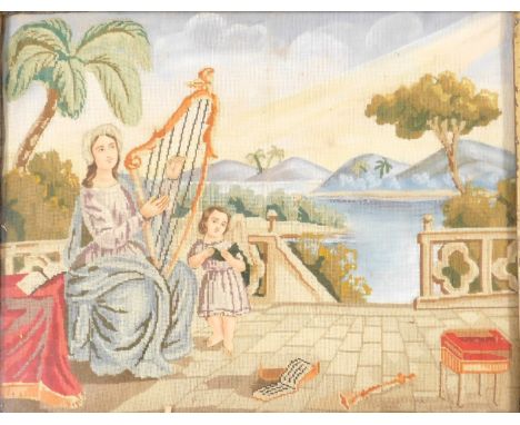 A late 18thC wool work and felt work picture, of a lady playing a harp, with a child, beside a river, 28.5cm x 36cm.
