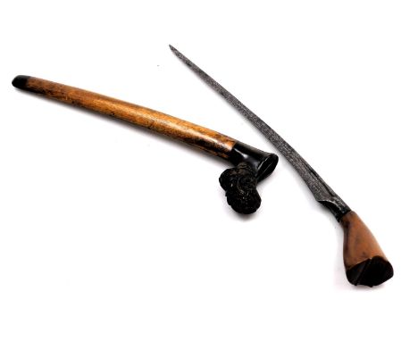 An early 20thC Malayan or Sumatran Tumbok Lada, with a carved wooden handle and curved steel blade, the scabbard with a horn 