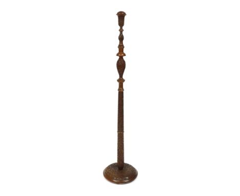 An early 20thC Anglo Indian carved hardwood standard lamp column, decorated with fruit and leaves, on a circular base, 150cm 