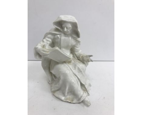 An 18th Century Bow figure blanc de chine study of "A nun seated reading", bearing old handwritten label to underside "The ..