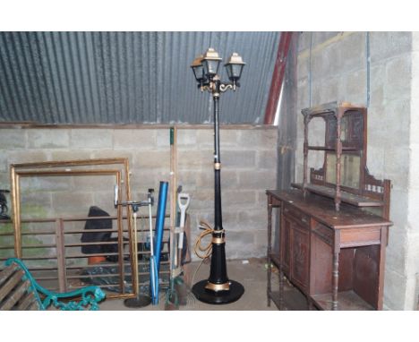 A garden light in the form of a three branch street lamp