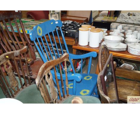 A painted stick back rocking chair