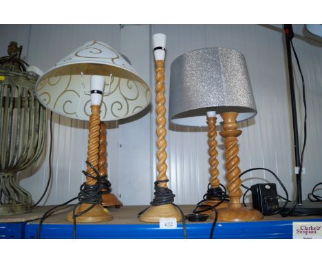 Five various barley twist table lamps and a candle stick