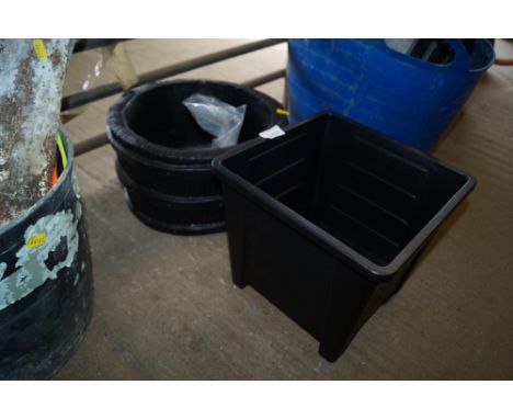 A plastic plant pot and a concrete planter