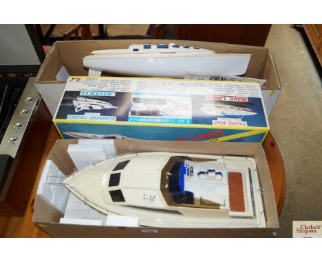 A radio controlled wave liner model boat and a model boat hull lacking controllers and accessories