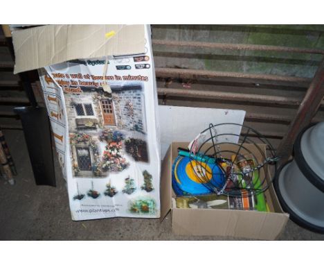 A box containing hanging plastic plant pots; and a box of various gardening items to include hose pipe, hand fork and spade e