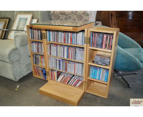 A light oak CD storage unit and contents of various CD's