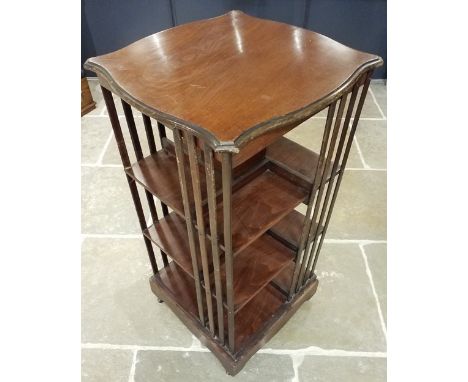 * Bookcase. A mahogany revolving bookcase, early 20th century, the square serpentine-shaped top above shelves and vertical sl
