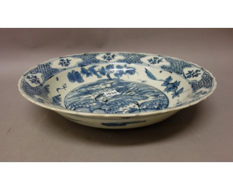 A large Chinese Swatow ware blue and white deep dish, late Ming dynasty, late 16th/17th century, painted in the centre with a