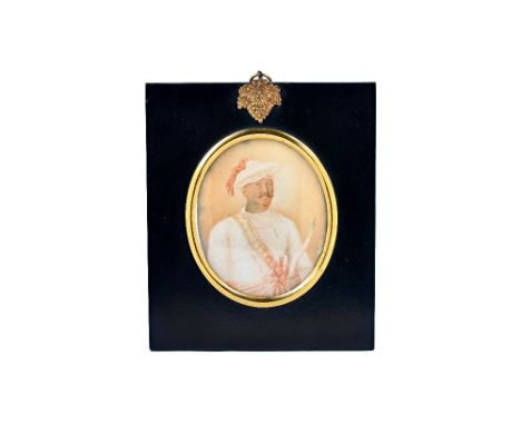 A late 18th/early 19th century Anglo-Indian 'Company School' portrait miniature on ivory of a gentleman wearing a flattened t