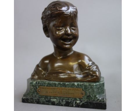 After Donatello; a patinated bronze bust of a young smiling boy, signed, on a marble plinth with commemorative plaque dated 1