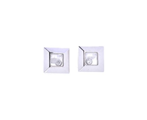 A pair of Chopard, white gold and diamond set ear studs, each of square form, glazed to the centre, with a circular cut loose