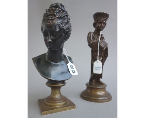 A French patinated bronze bust of Diana, late 19th century, on a later socle, 23.5cm high, and a bronze figure depicting a yo