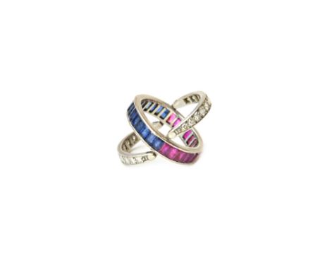 A diamond, ruby and sapphire set night and day swing over and under eternity ring, the principle band mounted with calibre cu