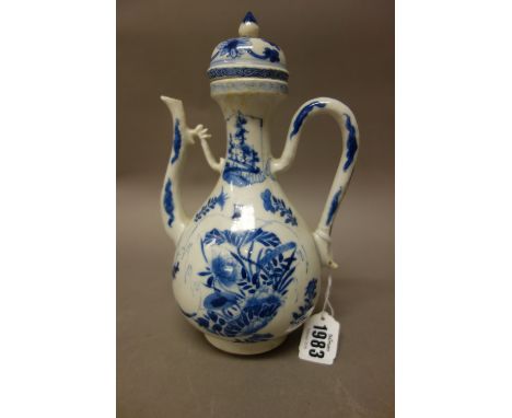 A Chinese blue and white wine ewer and matched cover, Kangxi, of pear form, each side painted with flowers, the waisted neck 