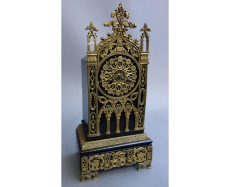 A French ebonised wood and brass mounted mantel clock, early 20th century, of 'cathedral' form, enclosing a two train movemen