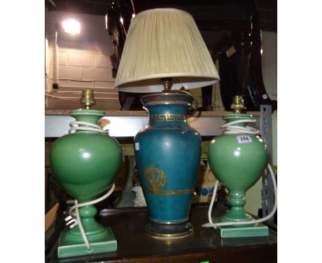 A pair of green pottery table lamps and a blue and gilt table lamp, (3).  I3