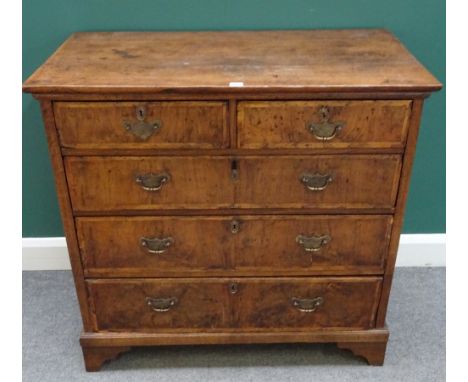 An early 18th century figured walnut and oak chest of two short and three long graduated drawers, on bracket feet, 100cm wide