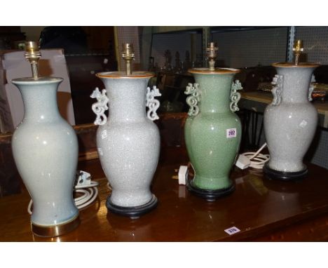 A pair of 20th century grey crackle glazed table lamps, a matching green lamp and one further green crackled lamp, (4).  J2
