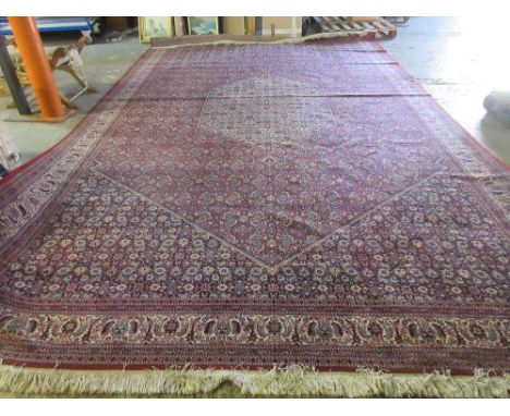 A machine made carpet of Persian design.  Please note that this lot is subject to VAT on the hammer