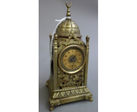 A Turkish brass cased mantel clock, 20th century, with domed top over a square turret body, with brass dial and inset hardsto