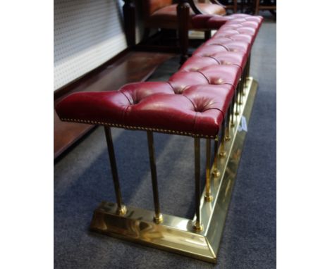 A Victorian style gilt metal and button back upholstered club fender, with square rails and a shaped kerb, 155cm wide.