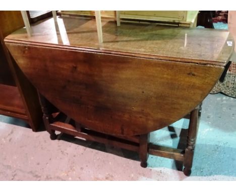 An 18th century style oak gate leg dining table, 113cm wide x 71cm high.  I6