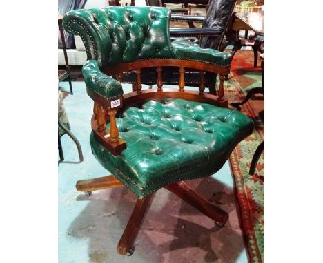 A Victorian style mahogany captain's swivel desk chair, with green leather button back upholstery.  E5