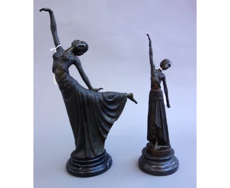 Two Art Deco style modern bronze dancing figures, each raised atop a turned stepped marble plinth, the tallest 41.5cm high, (