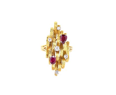 An 18ct gold, diamond and ruby seven stone ring, claw set with five circuclar cut diamonds, a pear shaped ruby and with an ov