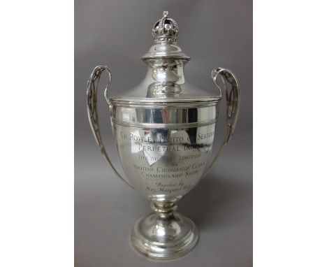 A silver twin handled trophy cup and cover, of urn shaped form, the handles pierced with the monogram ER V11, the detachable 