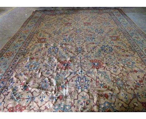 A Tabriz carpet, Persian, the brown field with an allover palmette and trellis design, with a complementary pale indigo palme