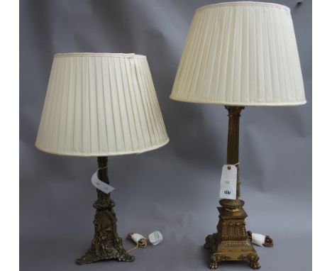 A Victorian brass table lamp of Corinthian column form, raised on lion paw feet, with a cream silk pleated shade, 88cm high o