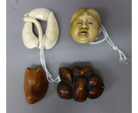 Four Japanese netsuke, Edo period, 19th century, comprising; an ivory mask of Okame, signed Shugetsu saku; a wood netsuke of 