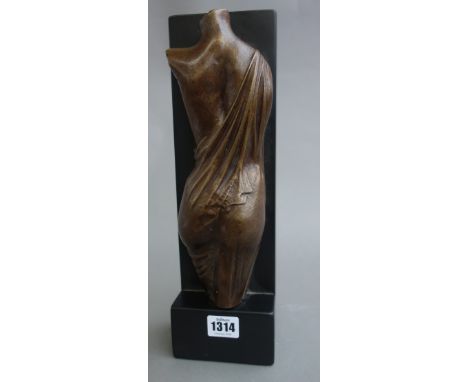 A bronze sculpture 'Statue on a Shelf', circa 1980, female torso against a black marble base, later signed, 34cm high. 